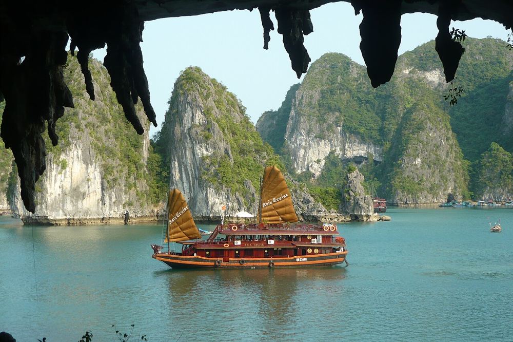 Junk boat seen from a cave in Ha Long Bay, Vietnam